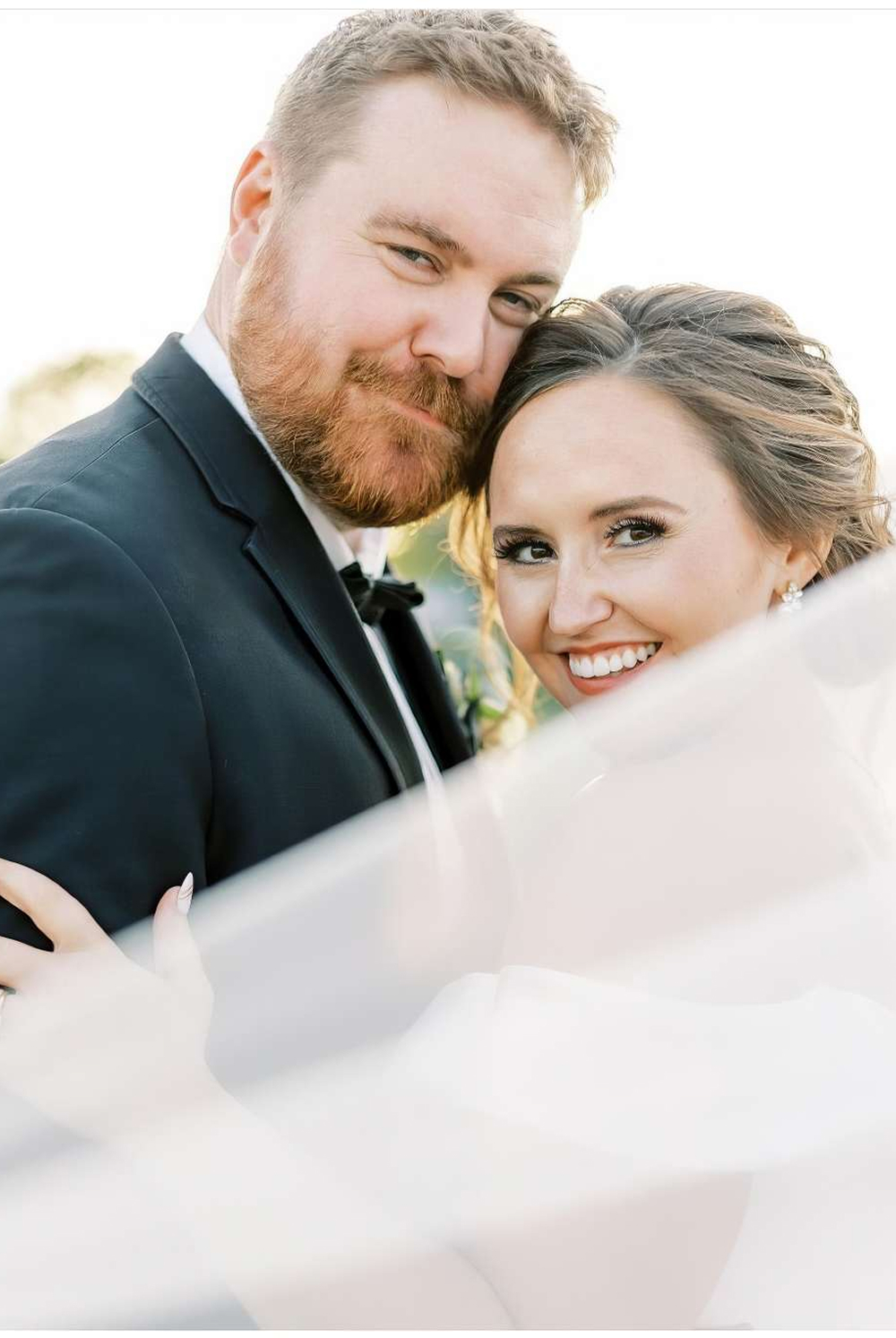 Bride and groom smiling at camera