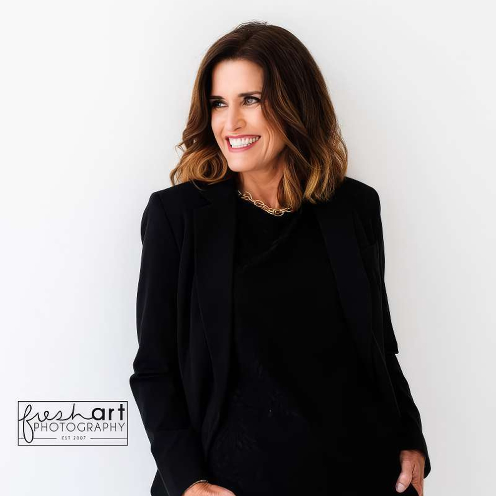 Woman in black suit smiling